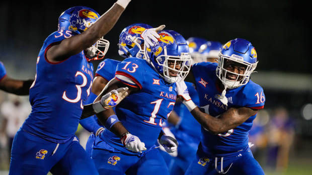 Sep 2, 2022; Lawrence, Kansas, USA; Kansas Jayhawks linebacker Eriq Gilyard (13) celebrates with teammates after an interception against the Tennessee Tech Golden Eagles during the second half at David Booth Kansas Memorial Stadium.